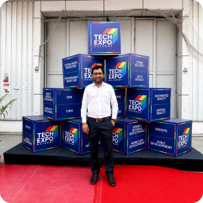 Visitor posing at the Tech Expo Gujarat 2024 exhibition venue outside the event hall.